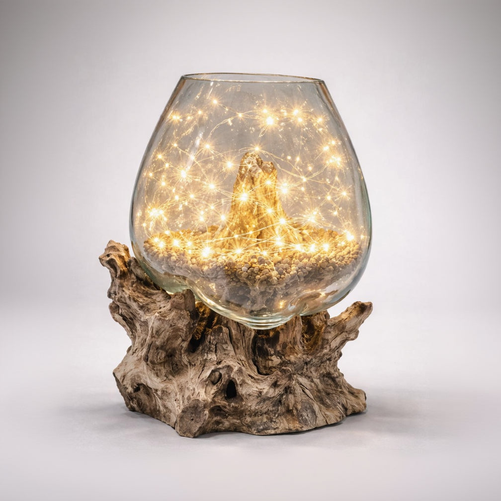 Glass bowl with lights on a wooden base against a gray background