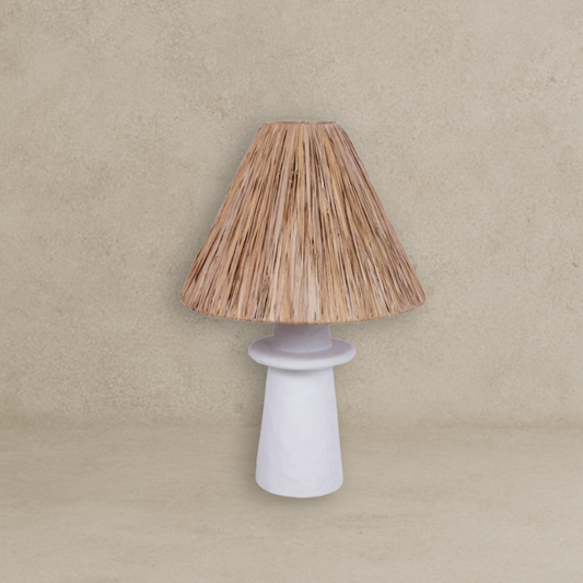 Lamp with a woven shade and white base on a beige background