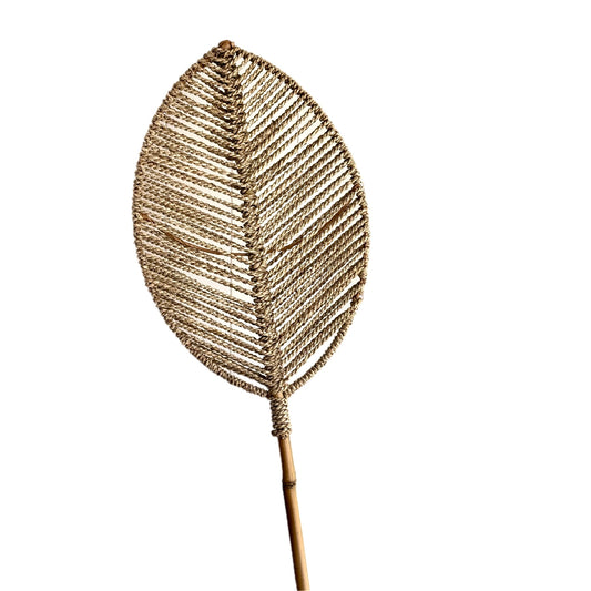 A handwoven decorative palm leaf made from natural plant fibers, mounted on a bamboo stem.