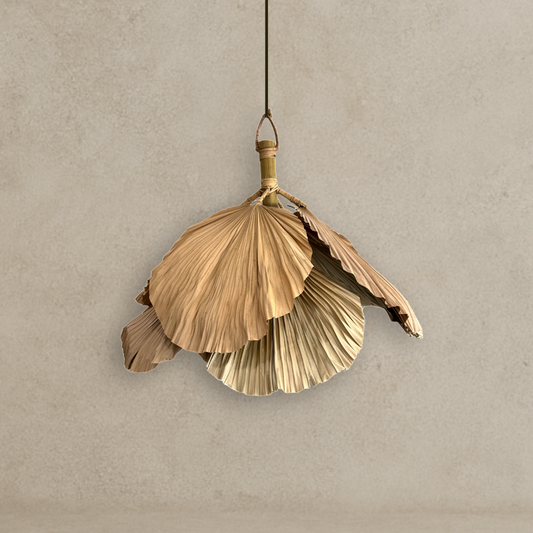 Decorative pendant light with leaf-like design on a beige background