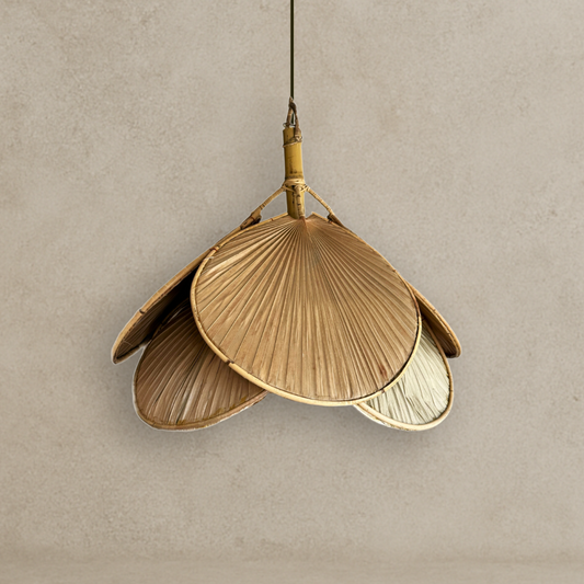 Decorative pendant light with leaf-like design on a beige background