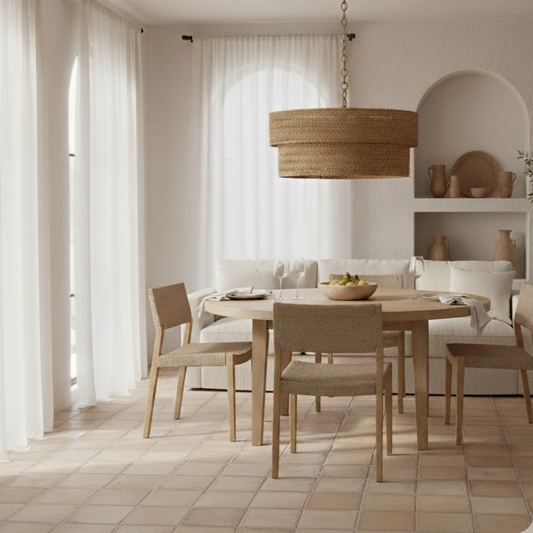 Dining room with wooden table and chairs, wicker pendant light, and white curtains.