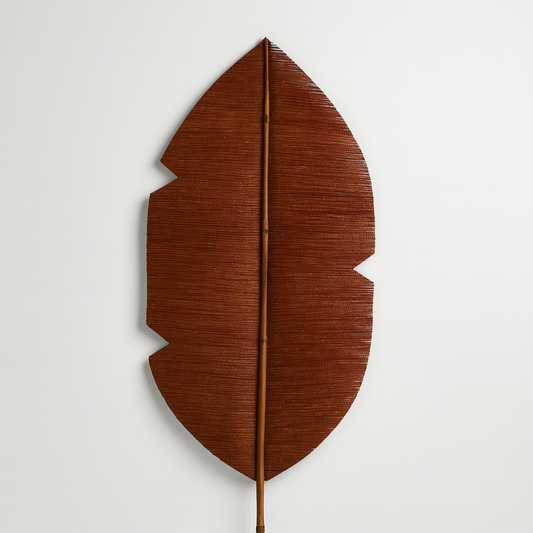 Brown leaf-shaped decorative item on a white background