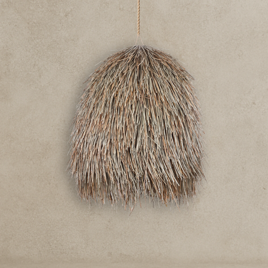 Woven basket hanging against a beige wall