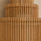 Close-up of a natural bamboo or rattan lampshade with vertical slats and woven horizontal bands, shown against a warm neutral background.