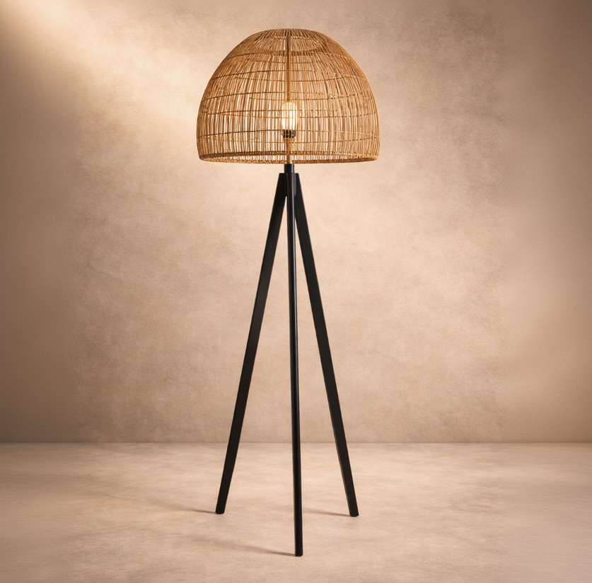 Floor lamp with wicker shade and black metal legs on a beige background