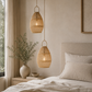 Bedroom with wicker pendant lights, a bed, and decorative elements.