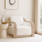 Modern white armchair in a minimalistic room with a abstract painting on the wall.