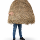 Person holding a large woven straw hat against a white background