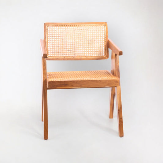 A rattan chair with handwoven rattan backrest and seat, teak wood frame, and armrests.