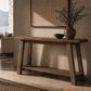 Wooden console table with decorative items in a living room setting