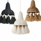 Three woven lampshades in black, white, and brown with tassels on a white background