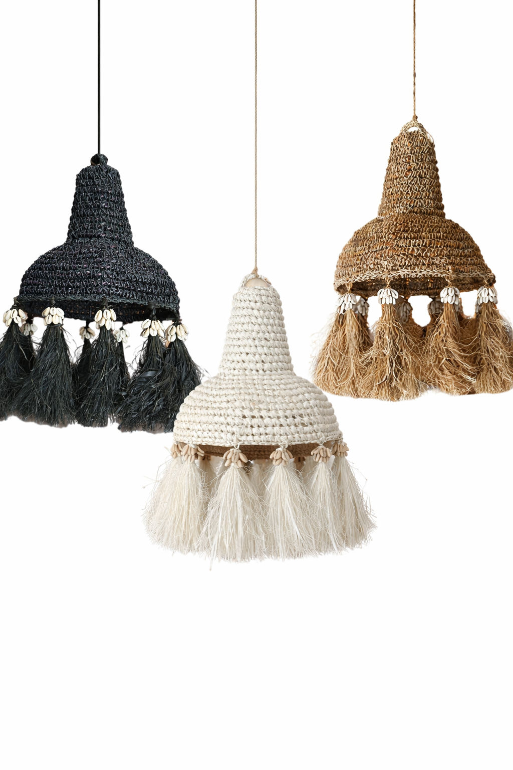 Three woven lampshades in black, white, and brown with tassels on a white background