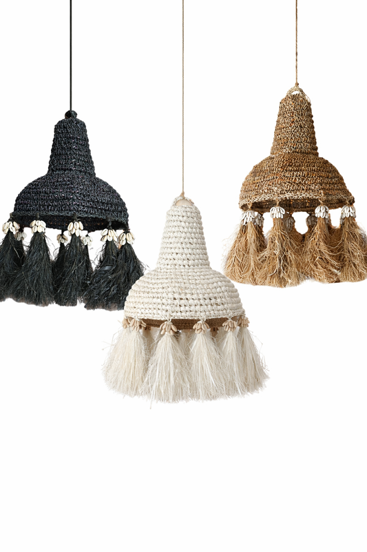 Three woven lampshades in black, white, and brown with tassels on a white background