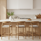 Modern kitchen with wooden stools at a island counter.